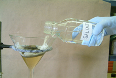 Picture of saline solution being poured into funnel
