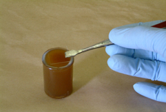fecal_flotation-1 picture of a slide being placed on a sample